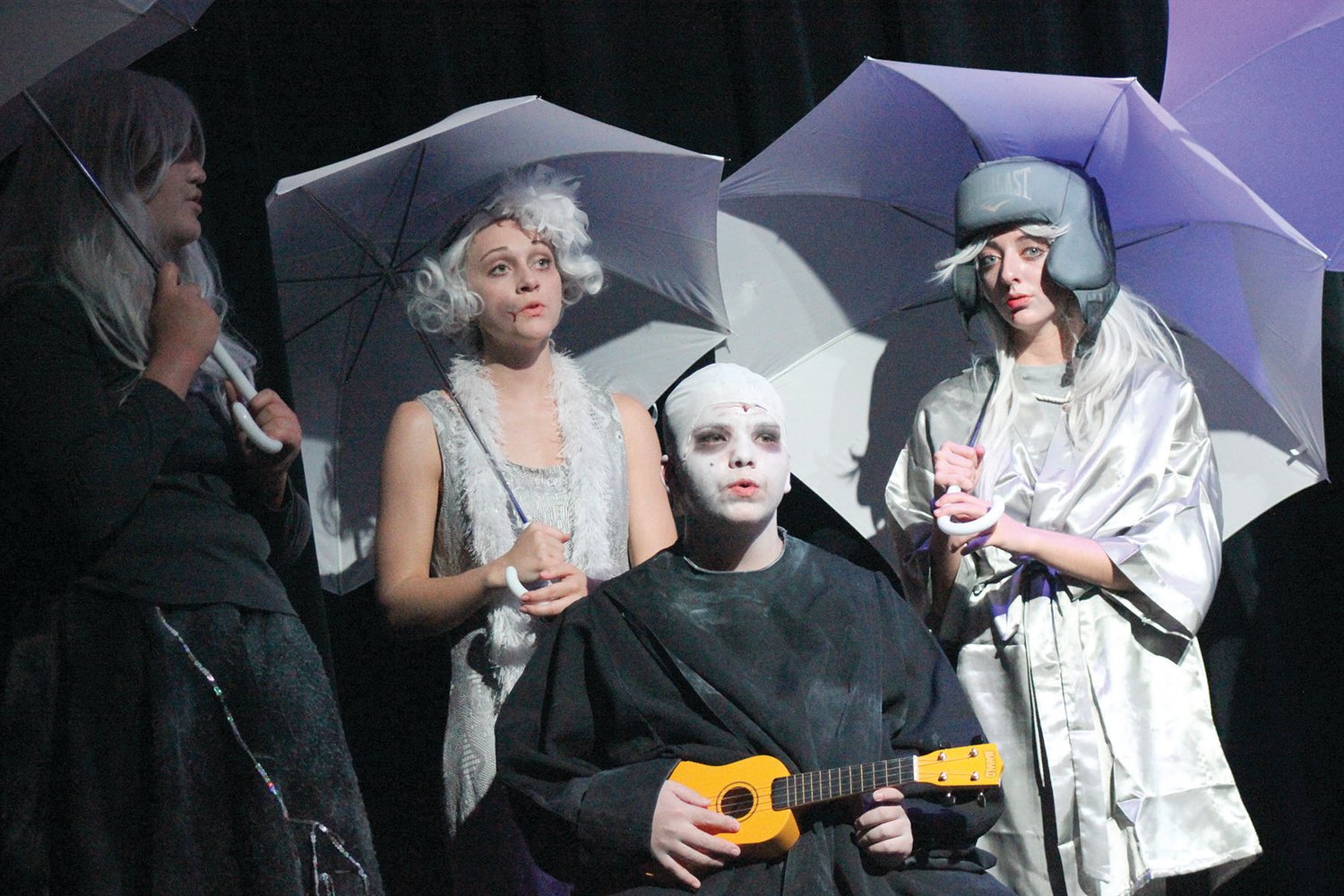 Uncle Fester (Josiah Schott) sings about his love for the moon with two ancestors behind him, from left, Audrey Ipock and Charis Alsup.